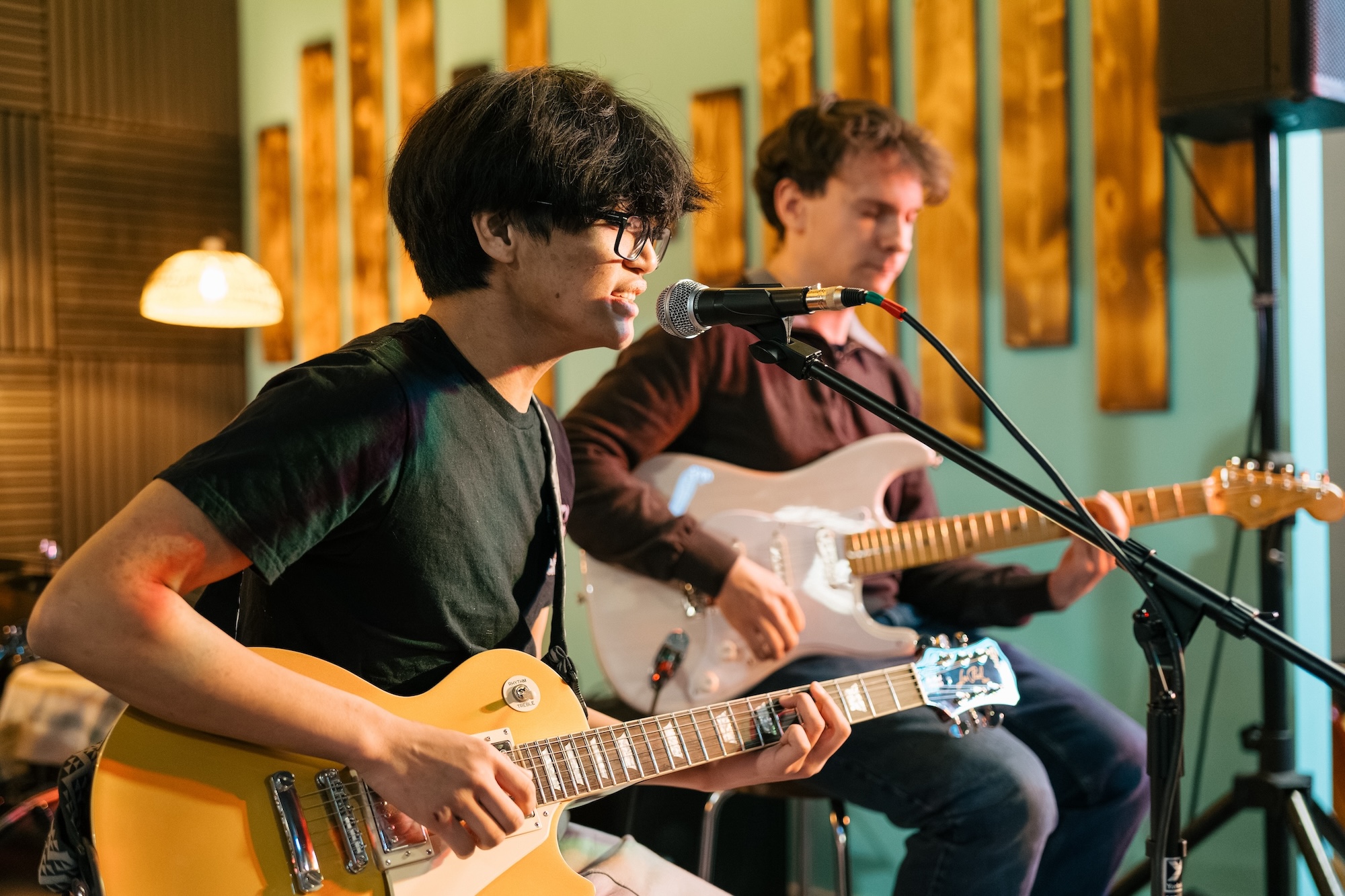 Two guitar players performing together at Resonate in Edmonton